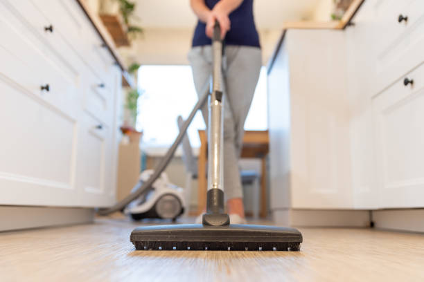 Lady cleaning floor with vacuum cleaner | Buckway Flooring