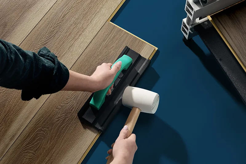 Worker installing COREtec LVP with tools